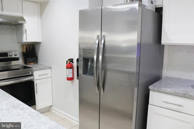 a kitchen with a refrigerator and a stove