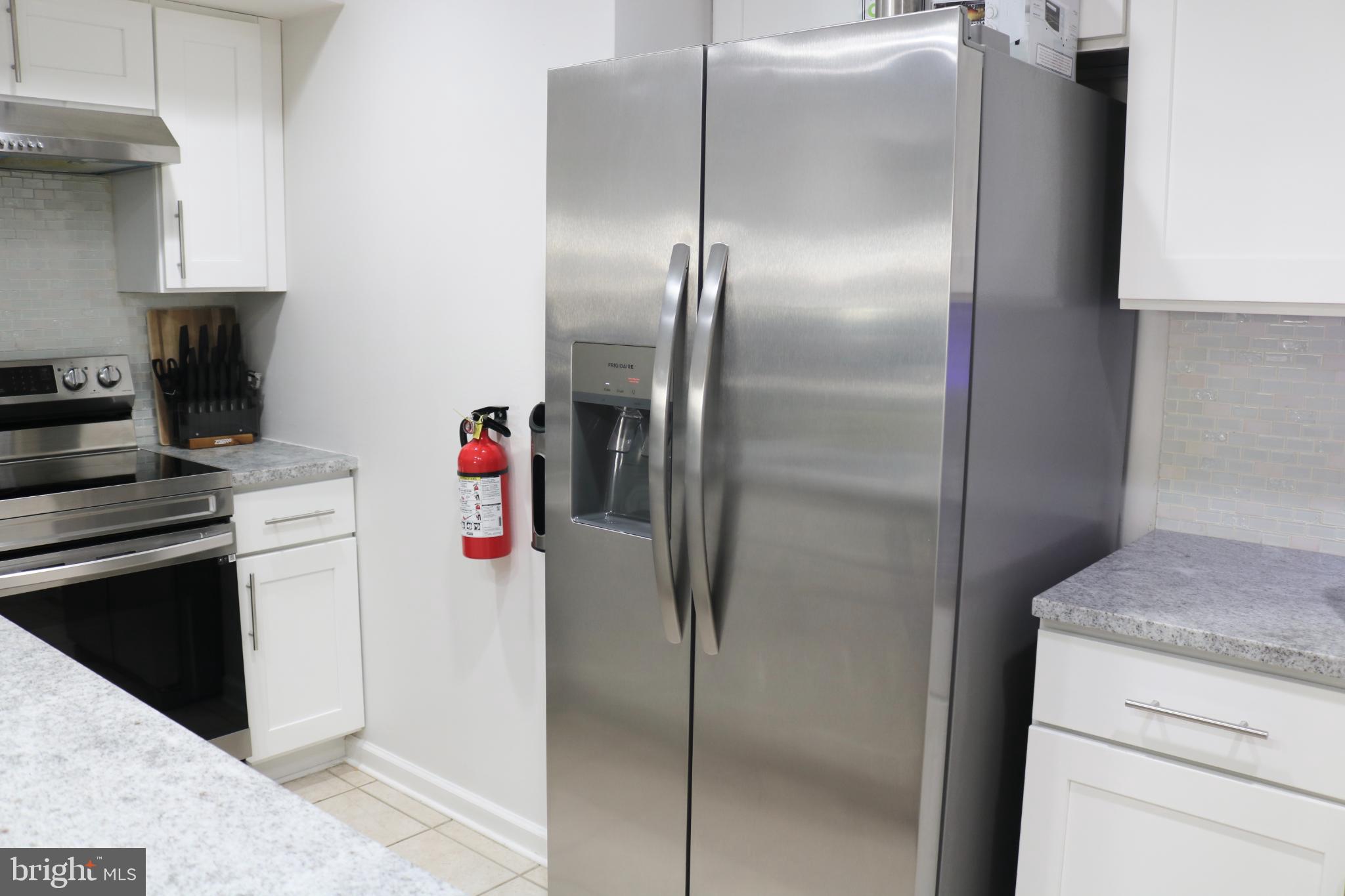 1031 Main Street Voorhees, NJ 08043 - Photo 21 of 32 a kitchen with a refrigerator and a stove