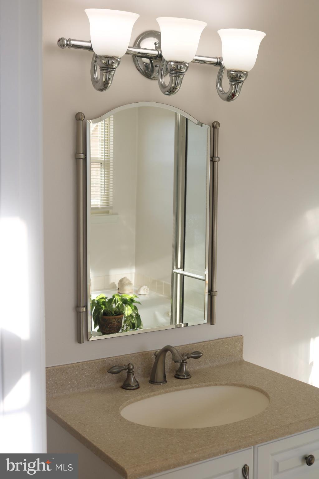 1031 Main Street Voorhees, NJ 08043 - Photo 3 of 32 a bathroom with a sink and a mirror