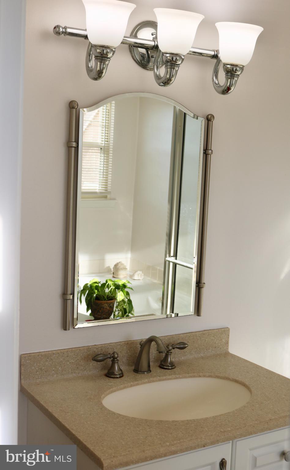 1031 Main Street Voorhees, NJ 08043 - Photo 32 of 32 a bathroom with a granite countertop sink and a mirror