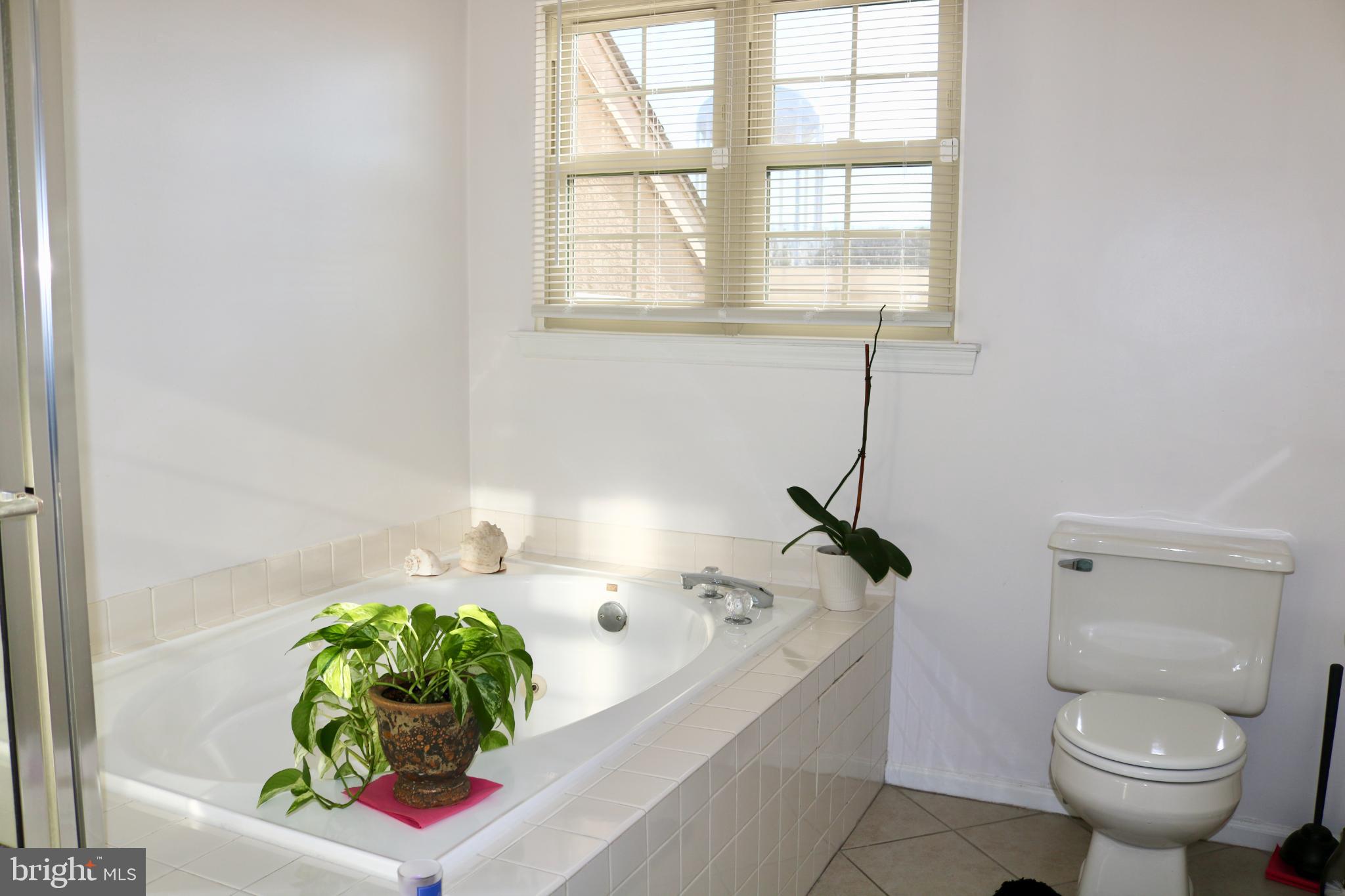 1031 Main Street Voorhees, NJ 08043 - Photo 4 of 32 a bath room with a toilet and a tub