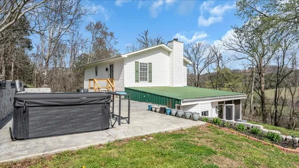 a view of backyard with seating space and trees
