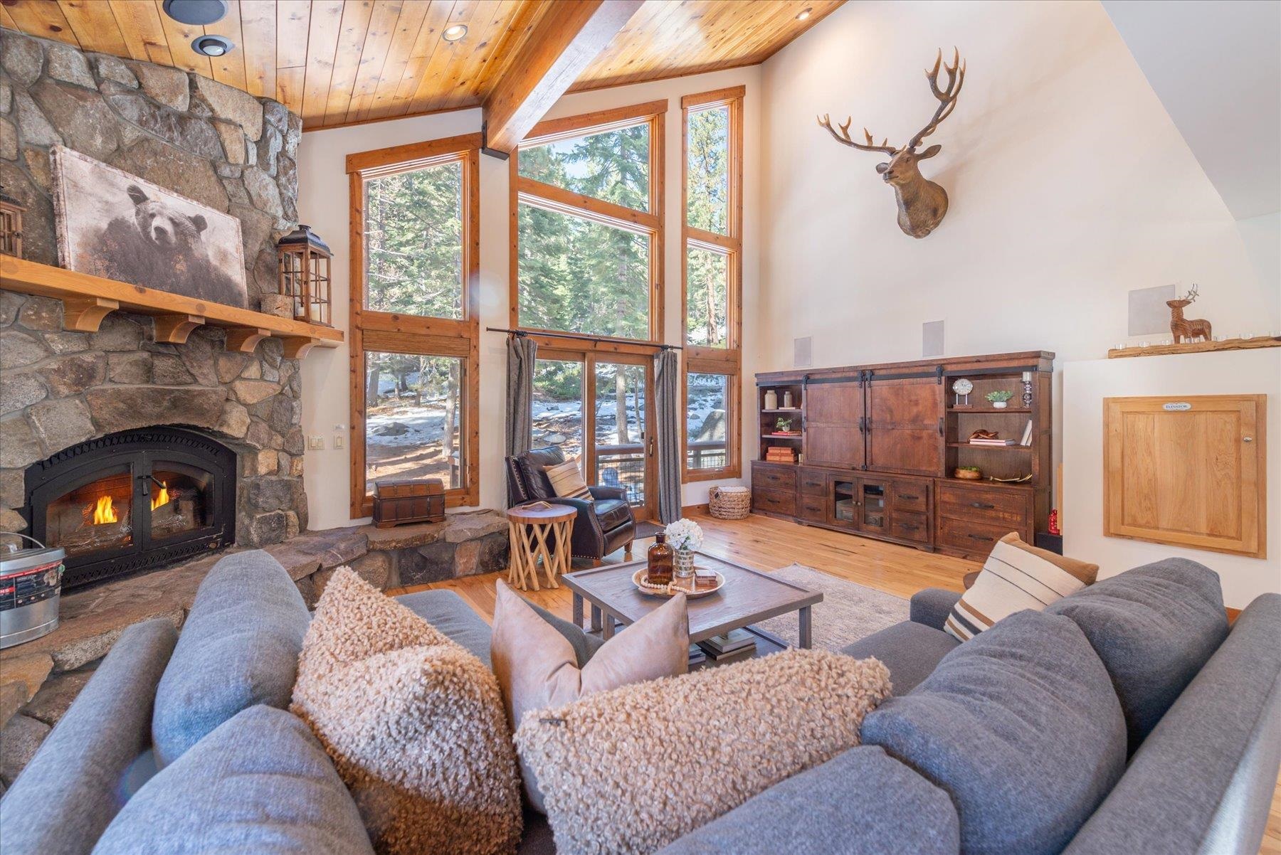 50830 Red Fir Terrace Soda Springs, CA 95728 - Photo 2 of 28 a living room with furniture a fireplace and a large window