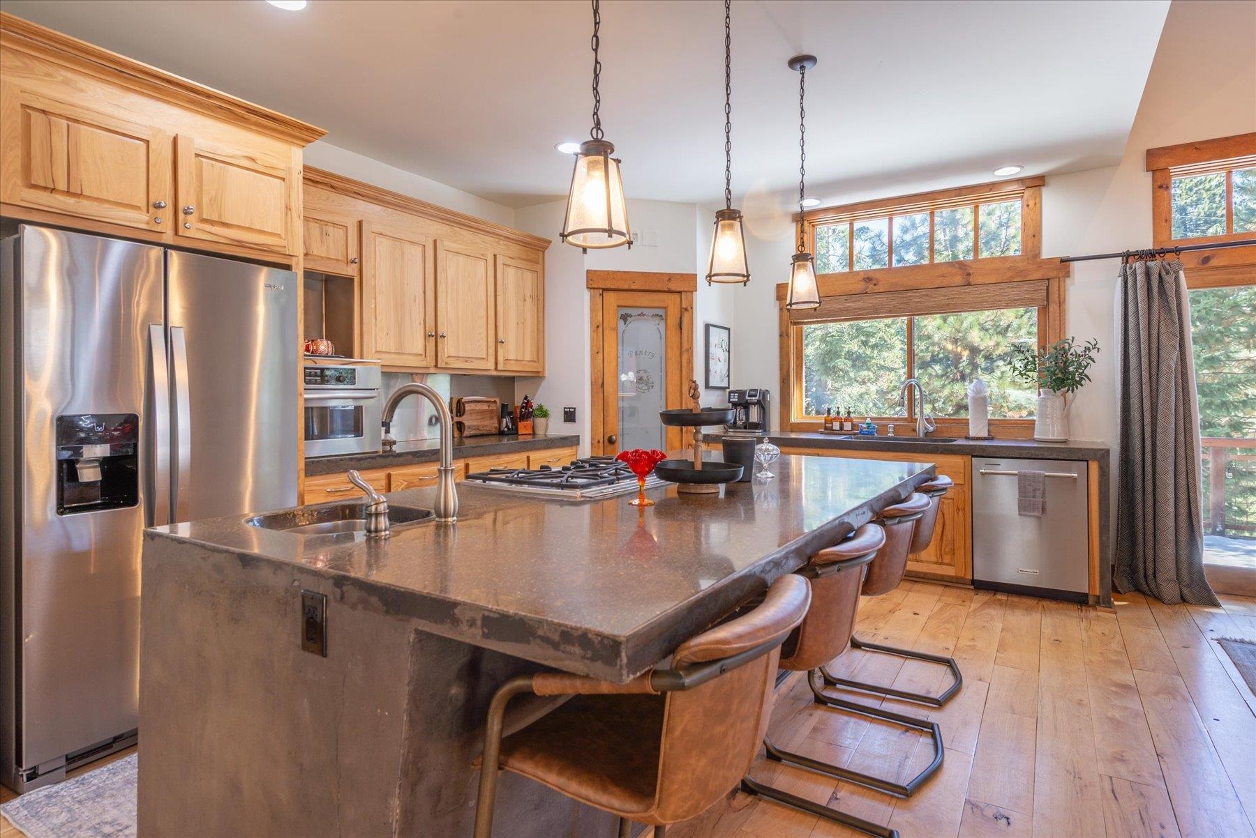 50830 Red Fir Terrace Soda Springs, CA 95728 - Photo 3 of 28 a kitchen with stainless steel appliances granite countertop a stove a refrigerator a kitchen island a stove and a refrigerator with wooden floor