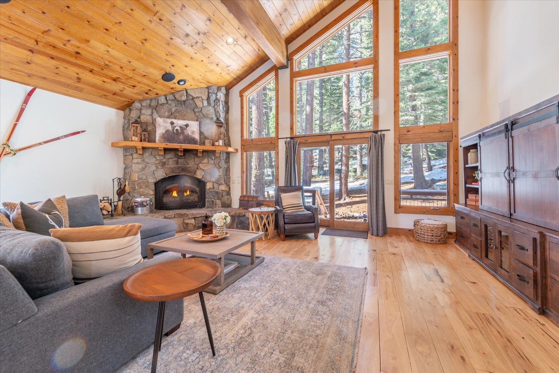 50830 Red Fir Terrace Soda Springs, CA 95728 - Photo 7 of 28 a living room with furniture a fireplace and a floor to ceiling window