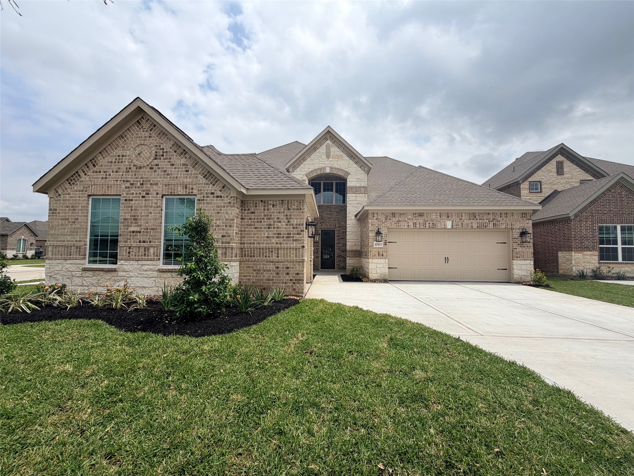 10503 Sutter Crk Drive Iowa Colony, TX 77583 - Photo 16 of 16 a front view of a house with a garden and plants
