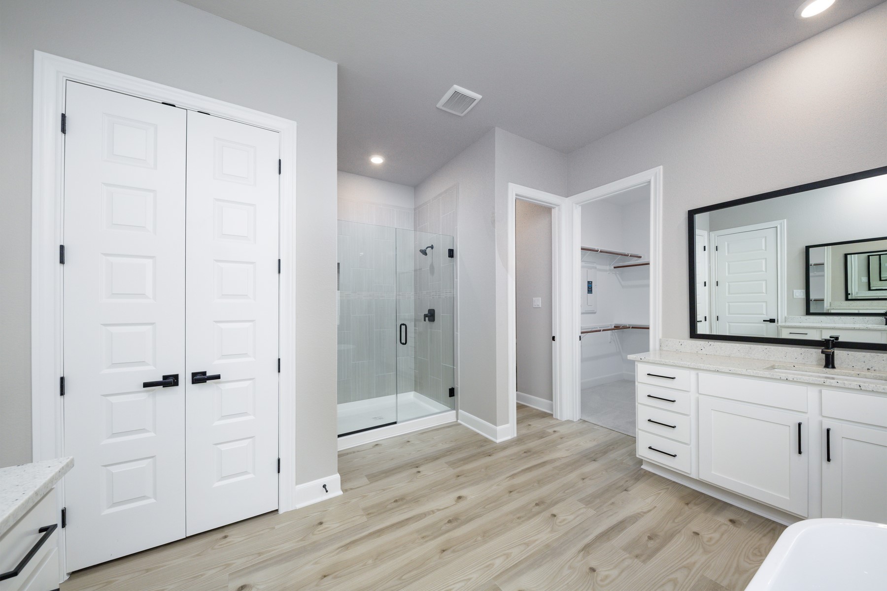 10503 Sutter Crk Drive Iowa Colony, TX 77583 - Photo 5 of 16 a spacious bathroom with a shower sink and mirror