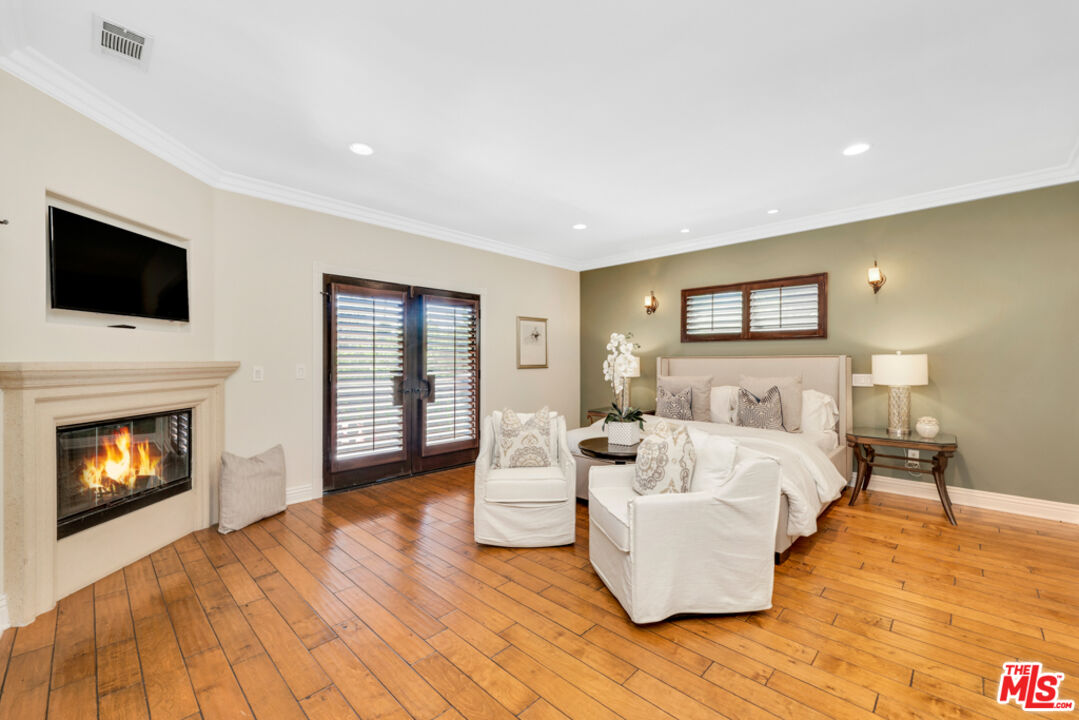 13834 Ordin Ranch Rd Valley Valley Glen, CA 91401 - Photo 17 of 35 a living room with furniture a fireplace and a flat screen tv