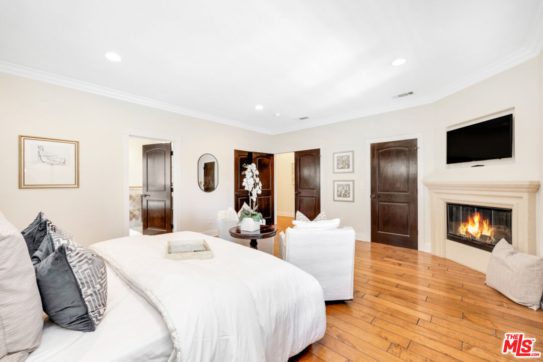 13834 Ordin Ranch Rd Valley Valley Glen, CA 91401 - Photo 18 of 35 a spacious bedroom with a bed and a flat screen tv