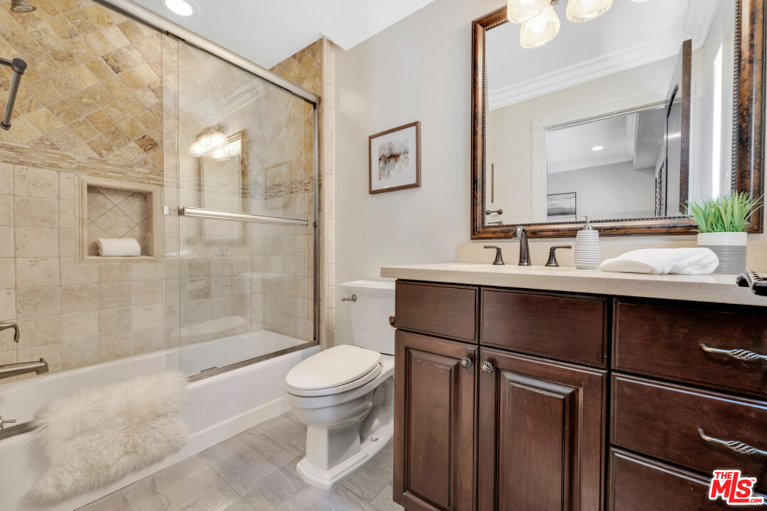 13834 Ordin Ranch Rd Valley Valley Glen, CA 91401 - Photo 23 of 35 a bathroom with a sink vanity mirror and toilet