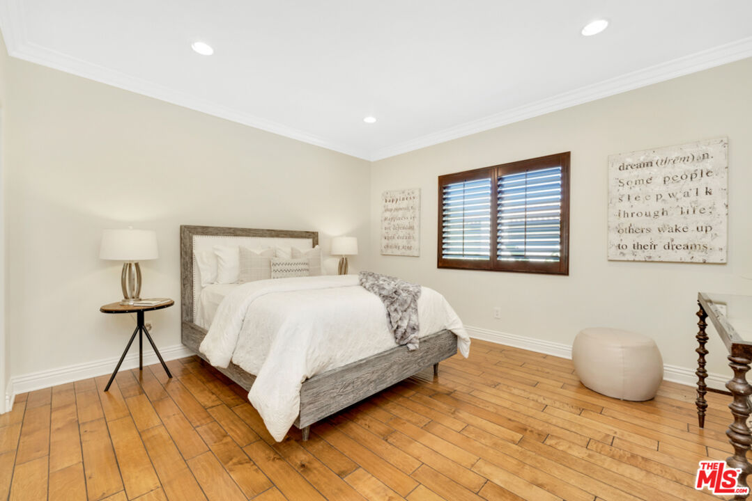 13834 Ordin Ranch Rd Valley Valley Glen, CA 91401 - Photo 24 of 35 a spacious bedroom with a bed and wooden floor