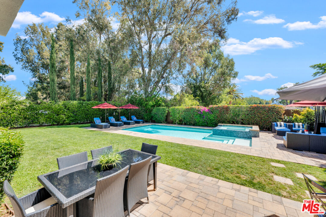 13834 Ordin Ranch Rd Valley Valley Glen, CA 91401 - Photo 29 of 35 a view of a swimming swimming pool with a yard and furniture