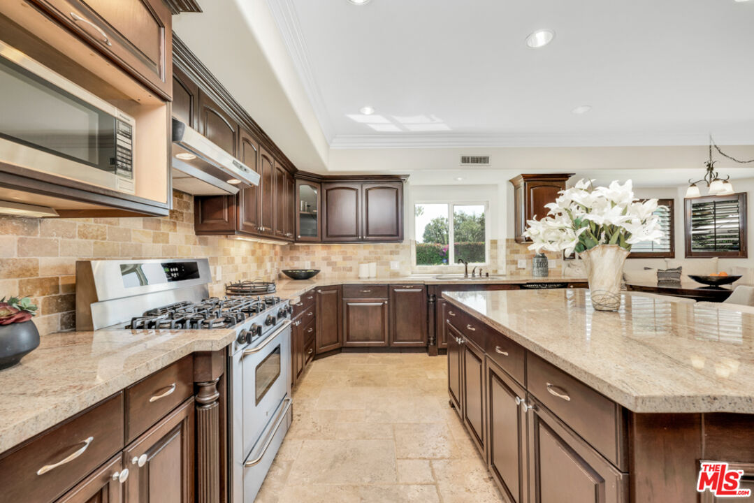 13834 Ordin Ranch Rd Valley Valley Glen, CA 91401 - Photo 9 of 35 a kitchen with stainless steel appliances granite countertop a sink stove and refrigerator