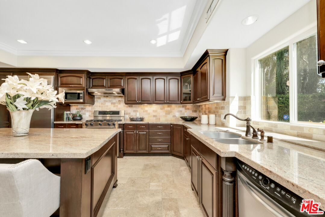 13834 Ordin Ranch Rd Valley Valley Glen, CA 91401 - Photo 10 of 35 a kitchen with kitchen island granite countertop a sink cabinets and window