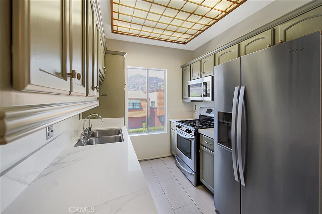 409 Burchett Street, Unit 315 Glendale, CA 91203 - Photo 12 of 34 a kitchen with stainless steel appliances granite countertop a refrigerator and a sink