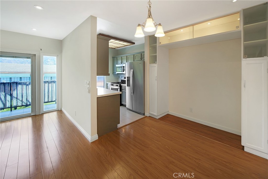 409 Burchett Street, Unit 315 Glendale, CA 91203 - Photo 14 of 34 a view of a hallway with wooden floor and a kitchen