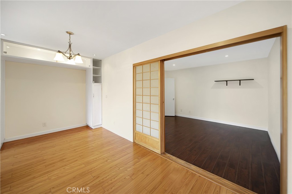 409 Burchett Street, Unit 315 Glendale, CA 91203 - Photo 18 of 34 a view of an empty room with wooden floor and a window