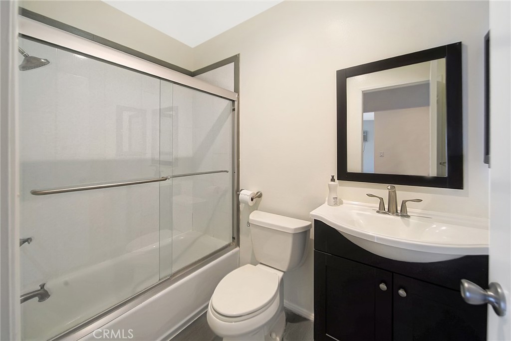 409 Burchett Street, Unit 315 Glendale, CA 91203 - Photo 21 of 34 a bathroom with a toilet a sink and a mirror