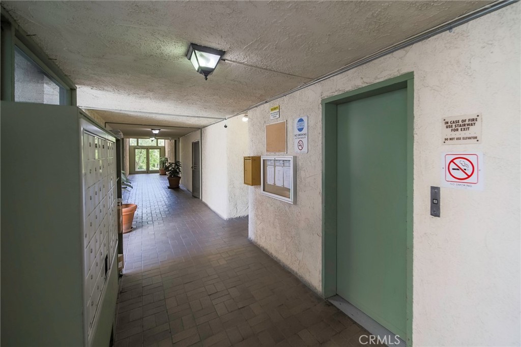 409 Burchett Street, Unit 315 Glendale, CA 91203 - Photo 27 of 34 a view of a hallway to an empty room with wooden floor and a window