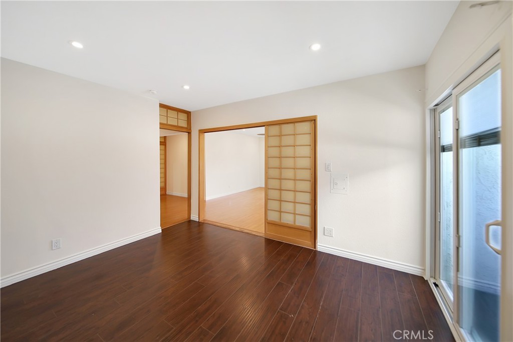 409 Burchett Street, Unit 315 Glendale, CA 91203 - Photo 6 of 34 an empty room with wooden floor and windows