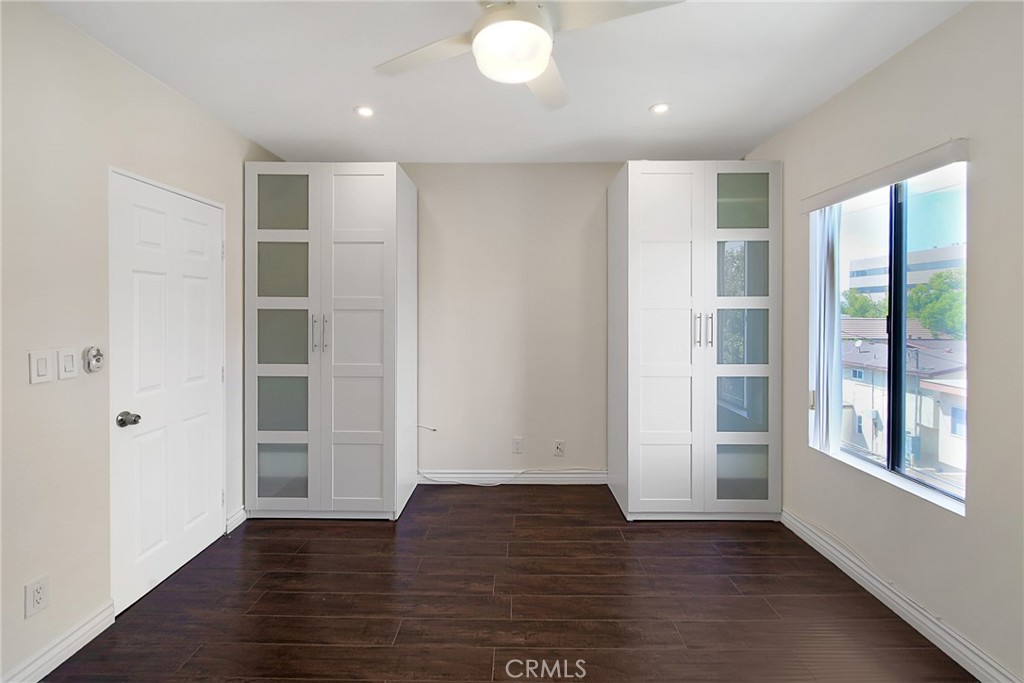 409 Burchett Street, Unit 315 Glendale, CA 91203 - Photo 7 of 34 an empty room with wooden floor and windows
