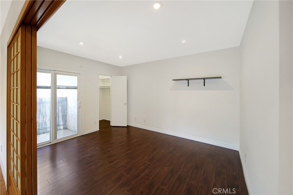 409 Burchett Street, Unit 315 Glendale, CA 91203 - Photo 10 of 34 a view of an empty room with wooden floor and a window