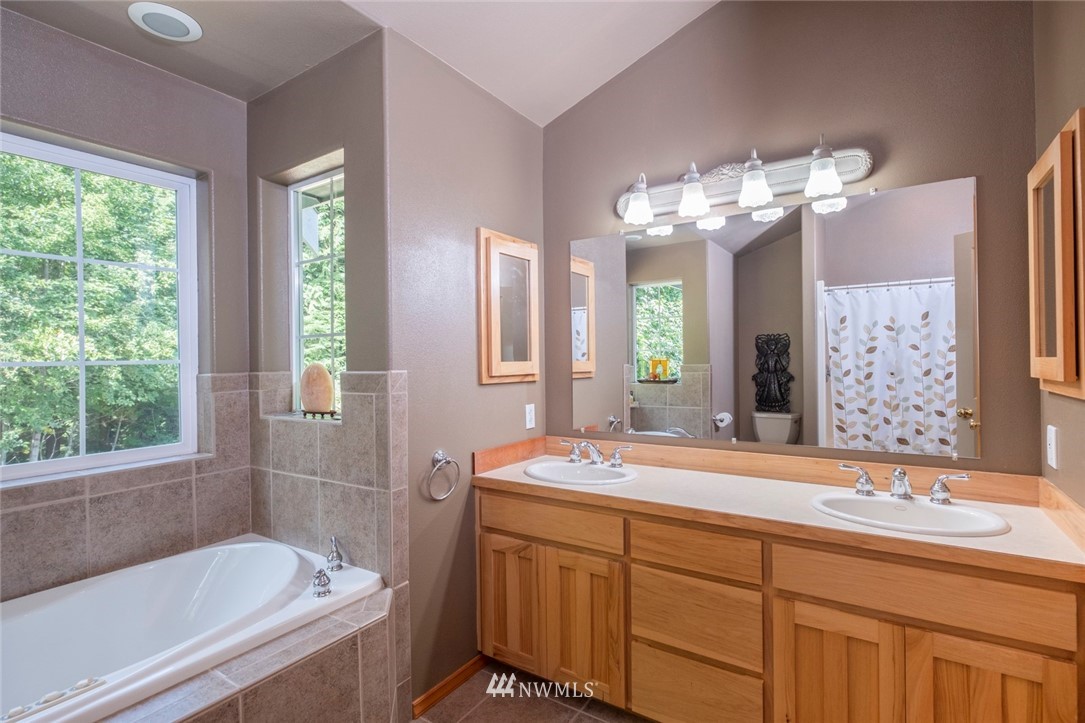 314 Walker Valley Road Port Angeles, WA 98362 - Photo 11 of 25 a bathroom with a tub sink and mirror