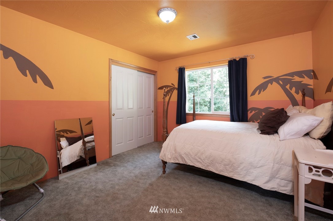314 Walker Valley Road Port Angeles, WA 98362 - Photo 13 of 25 a bedroom with a bed and a window