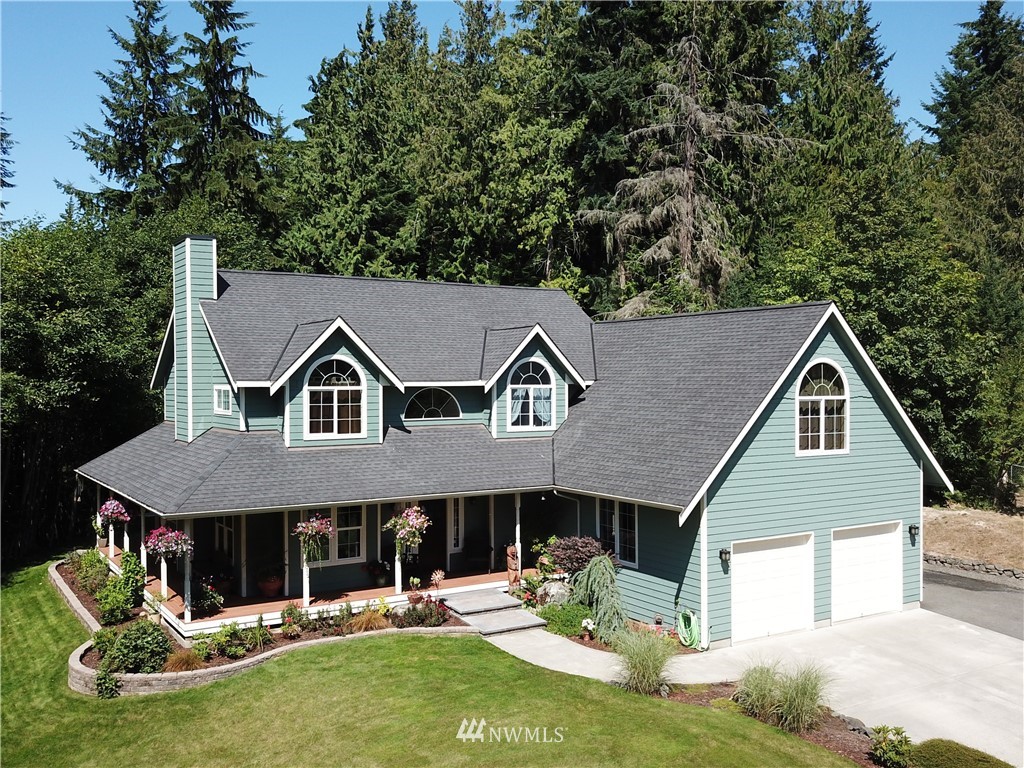 314 Walker Valley Road Port Angeles, WA 98362 - Photo 23 of 25 a front view of a house with a yard table and chairs