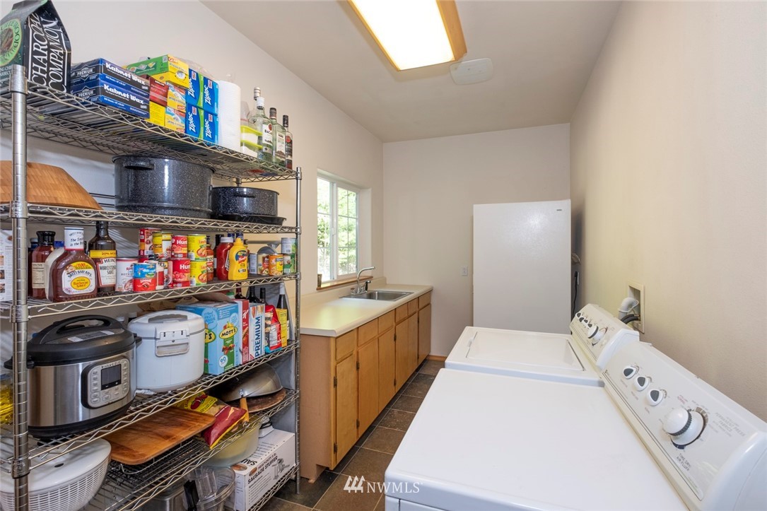 314 Walker Valley Road Port Angeles, WA 98362 - Photo 7 of 25 a kitchen with stainless steel appliances a stove a sink and a refrigerator