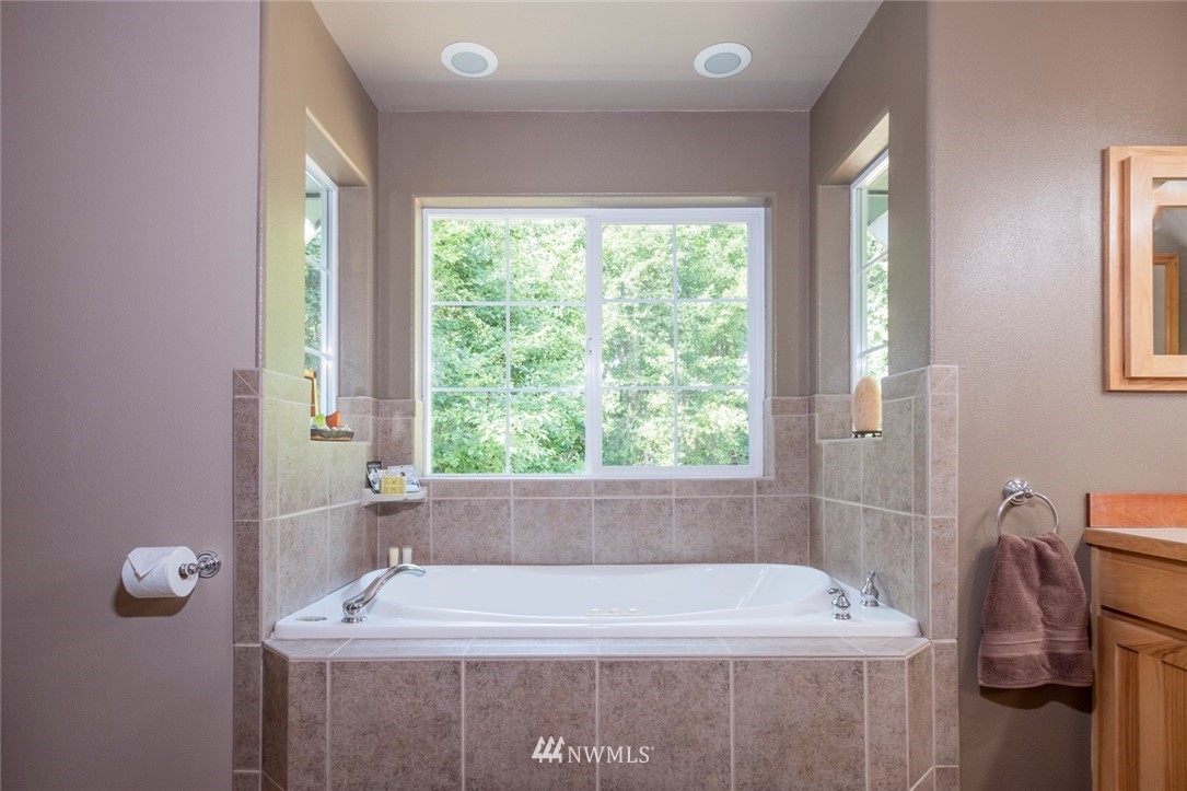 314 Walker Valley Road Port Angeles, WA 98362 - Photo 10 of 25 a bath tub sitting in a bathroom next to a window