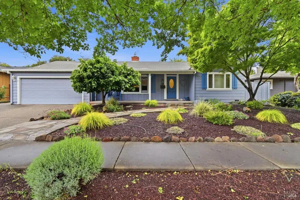 a front view of a house with garden