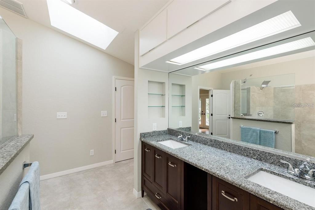5002 Southeast 7th Place Ocala, FL 34471 - Photo 15 of 30 a bathroom with a granite countertop sink and a mirror
