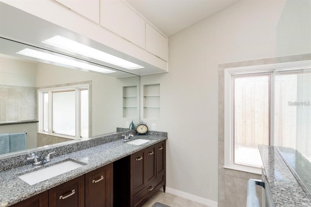 5002 Southeast 7th Place Ocala, FL 34471 - Photo 17 of 30 a bathroom with a granite countertop sink and a window