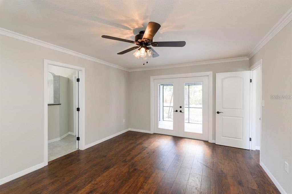 5002 Southeast 7th Place Ocala, FL 34471 - Photo 20 of 30 a view of a livingroom with a hardwood floor and a ceiling fan