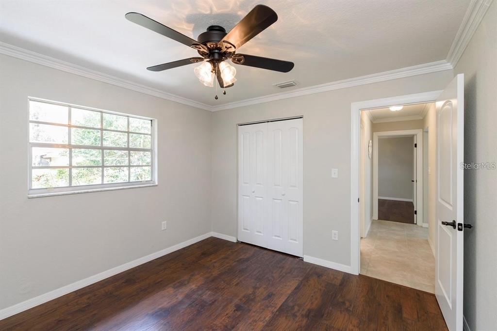 5002 Southeast 7th Place Ocala, FL 34471 - Photo 22 of 30 wooden floor in an empty room with a window