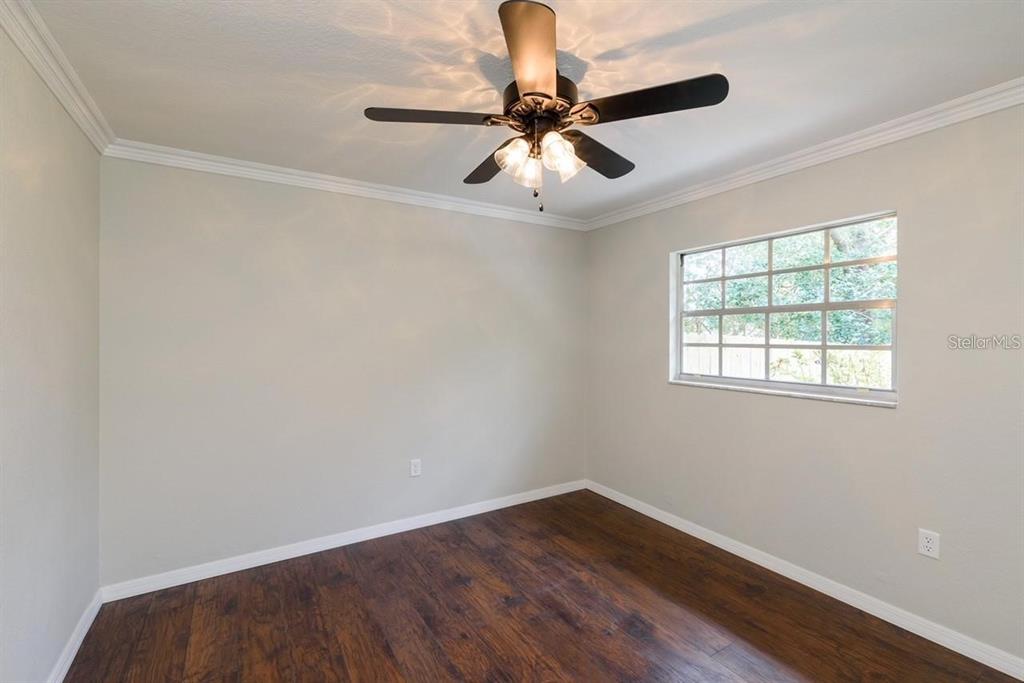 5002 Southeast 7th Place Ocala, FL 34471 - Photo 23 of 30 wooden floor in an empty room with a window