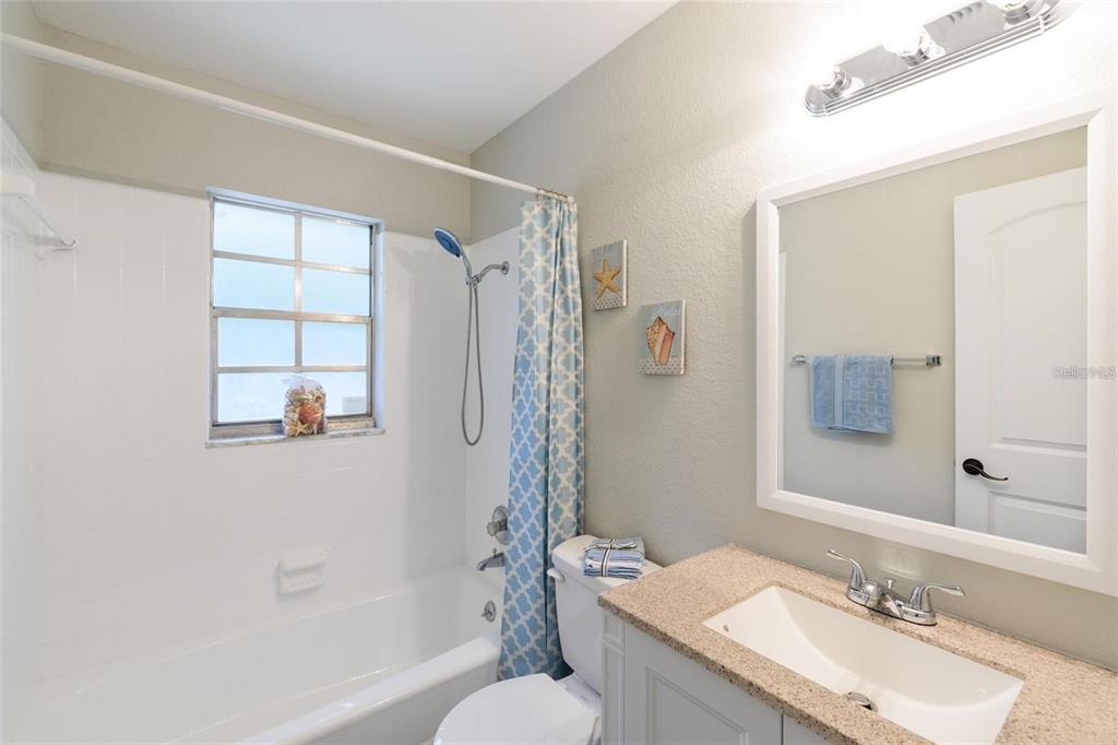 5002 Southeast 7th Place Ocala, FL 34471 - Photo 24 of 30 a bathroom with a granite countertop sink toilet and shower