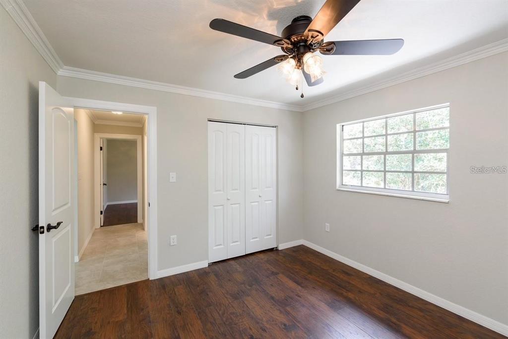 5002 Southeast 7th Place Ocala, FL 34471 - Photo 25 of 30 wooden floor in an empty room with a window