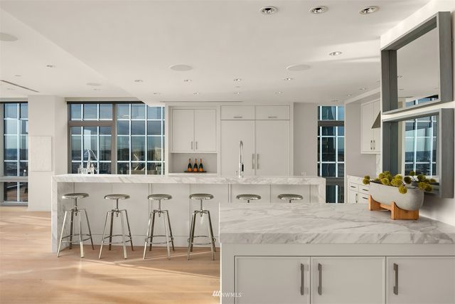 a kitchen with stainless steel appliances granite countertop a stove and cabinets