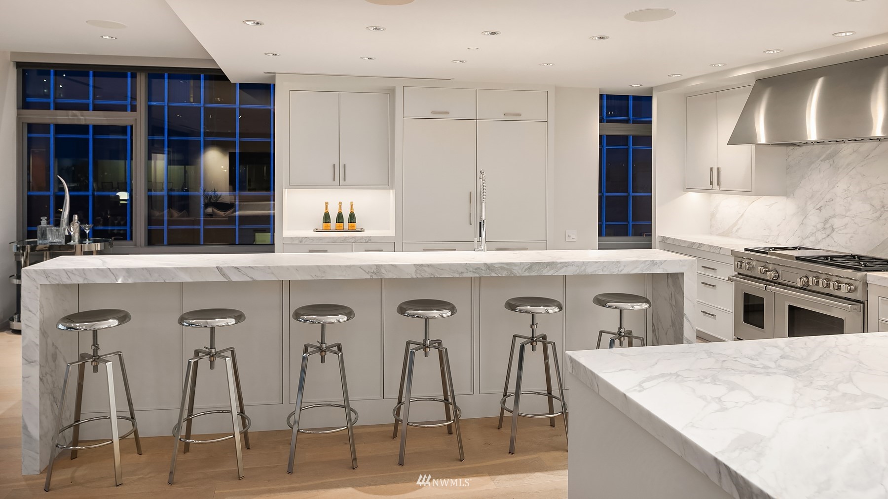 715 2nd Avenue, Unit 1702 Seattle, WA 98104 - Photo 12 of 26 a kitchen with stainless steel appliances kitchen island granite countertop a stove and white cabinets