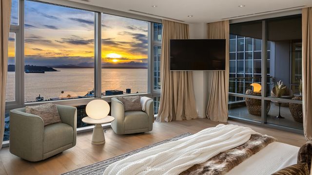 a living room with furniture a flat screen tv and a large window