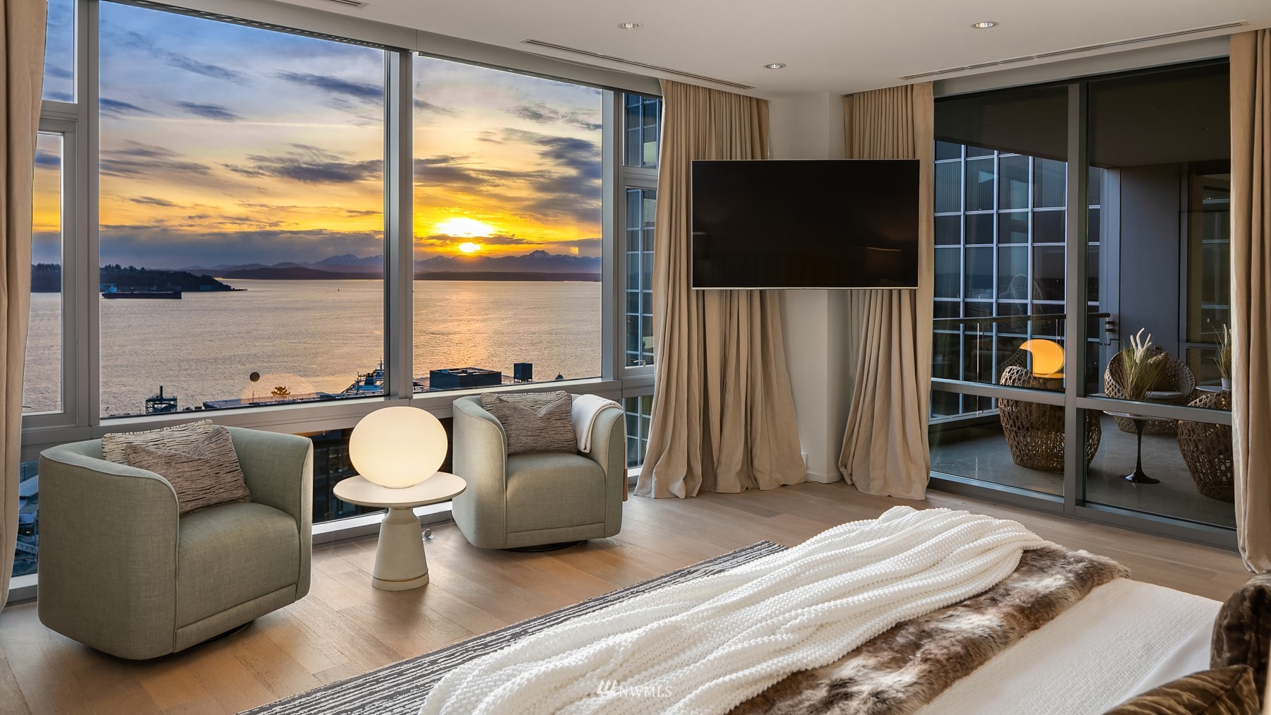 715 2nd Avenue, Unit 1702 Seattle, WA 98104 - Photo 14 of 26 a living room with furniture a flat screen tv and a large window