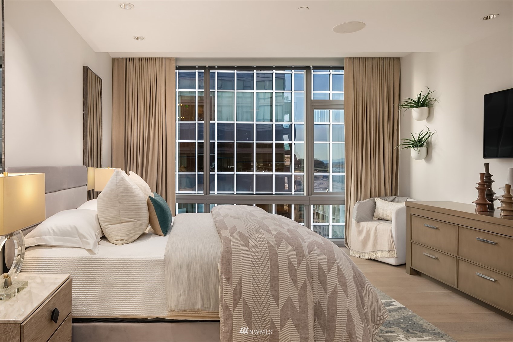 715 2nd Avenue, Unit 1702 Seattle, WA 98104 - Photo 19 of 26 a bedroom with a bed and a flat tv screen next to a window