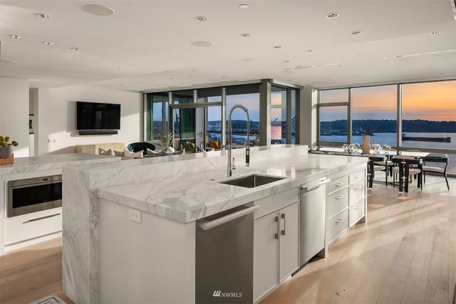 a kitchen with stainless steel appliances a sink and a stove