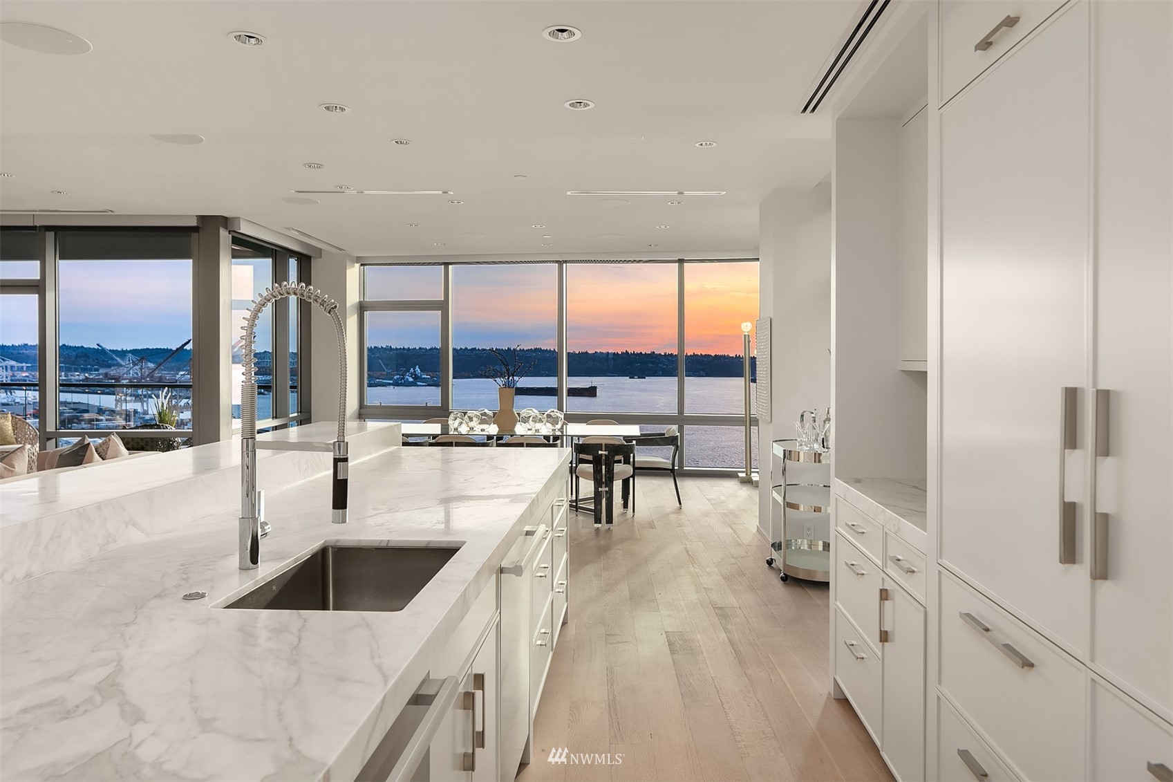 715 2nd Avenue, Unit 1702 Seattle, WA 98104 - Photo 9 of 26 a kitchen with stainless steel appliances granite countertop a sink and view of living room