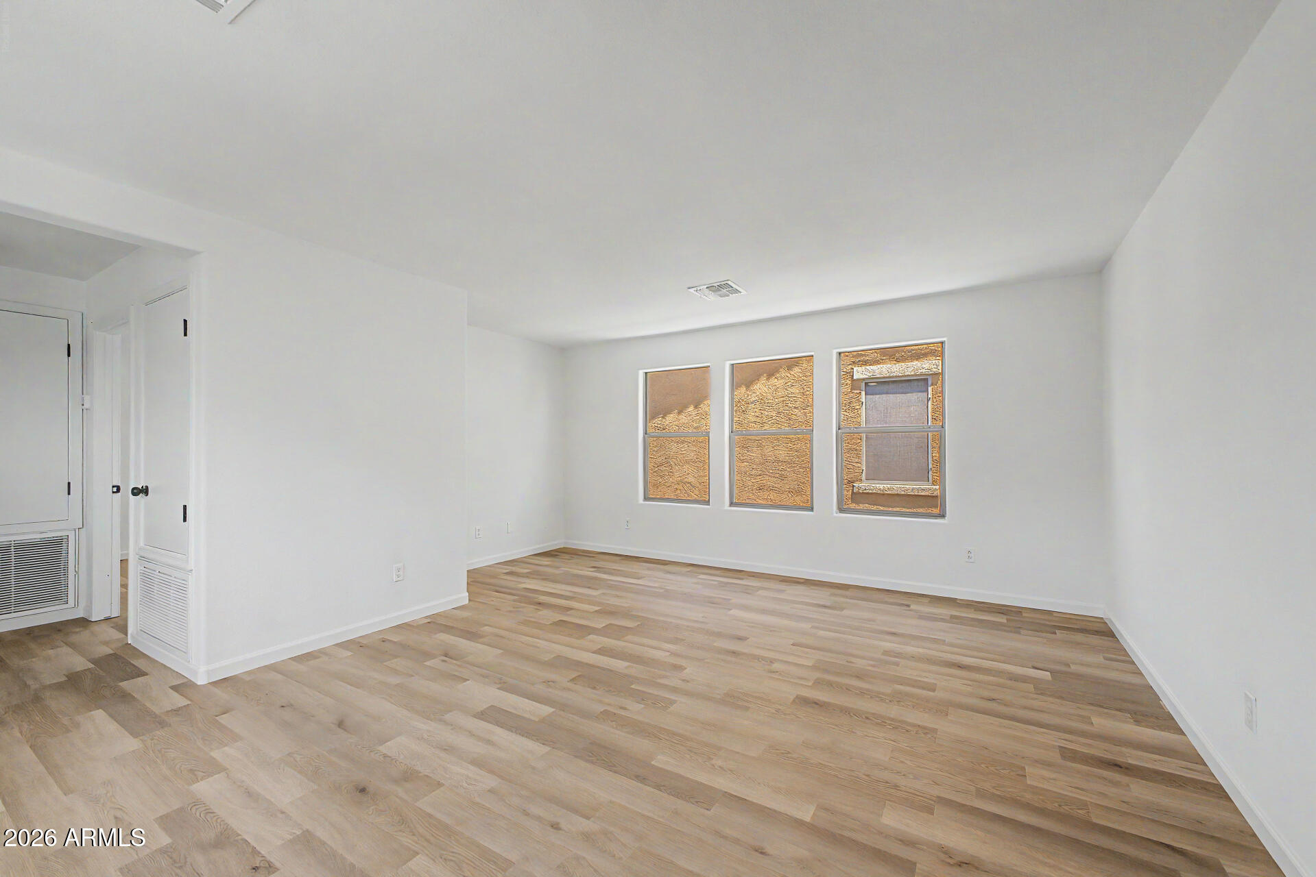 6452 West Ruth Avenue Glendale, AZ 85302 - Photo 17 of 35 a view of an empty room with wooden floor and a window