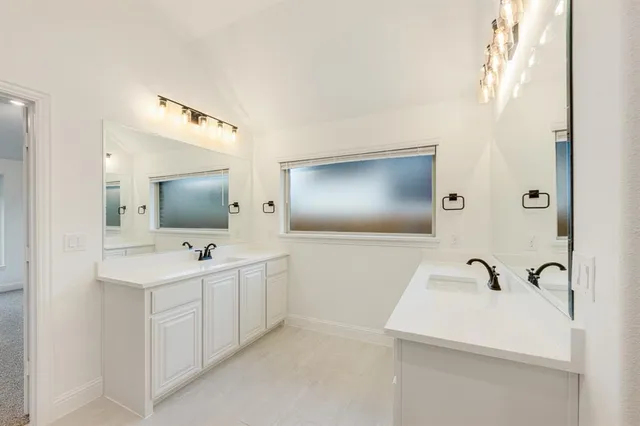 a bathroom with 2 sink and a mirror