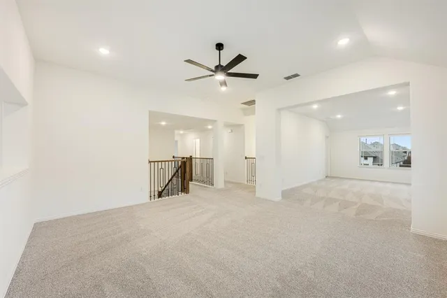 a view of a livingroom with a ceiling fan and window
