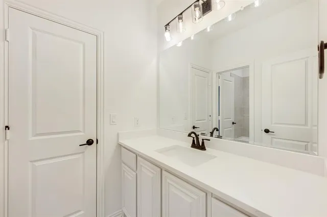 a bathroom with a sink a tub and a mirror